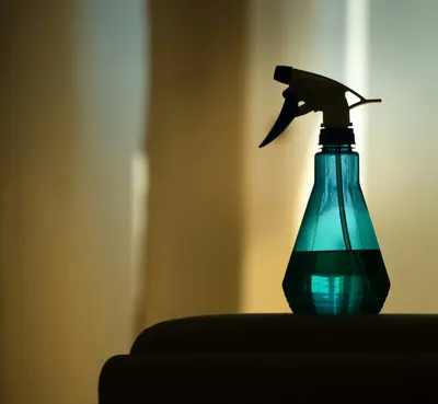 A spray bottle sitting on a surface in a home living room